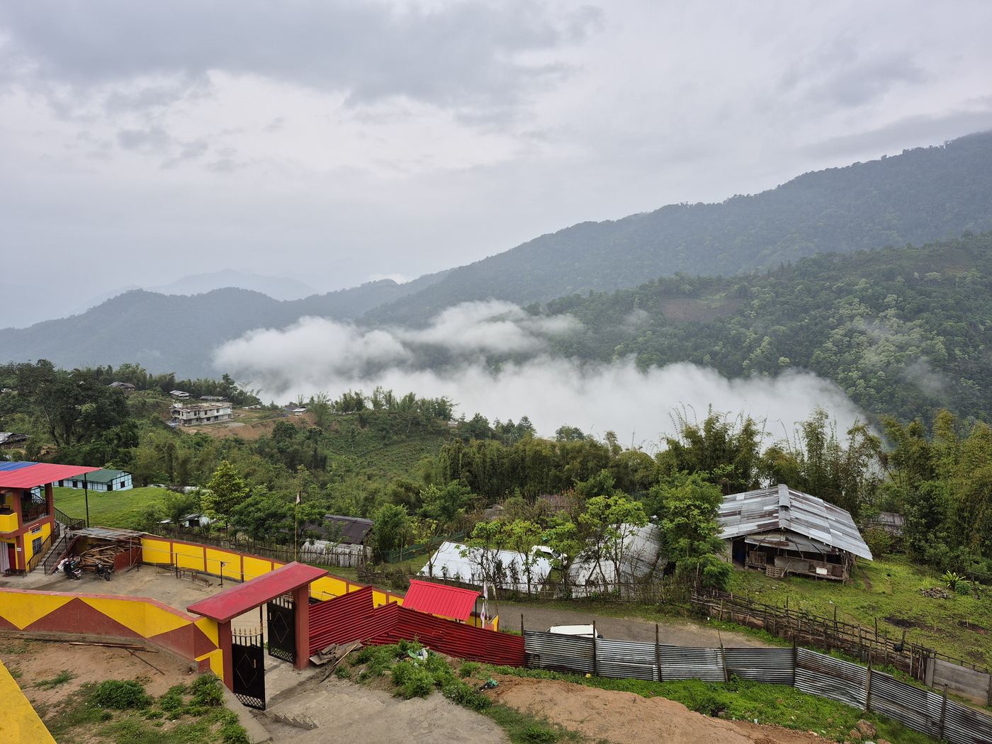 Clouds settling between green hills around Raga